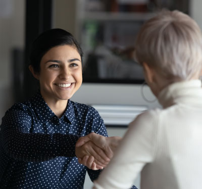 2 women shaking hands
